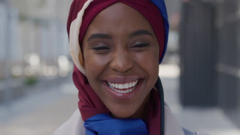 portrait happy african american business woman smiling in city urban scene