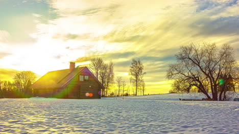 sunrise over a cottage in a snowy field surrounded by trees