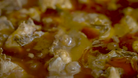 close up view of bubbling simmering chicken curry