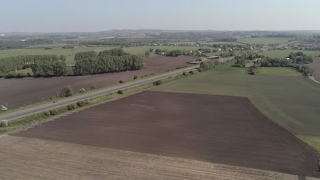 drone aerial slow rising view above british a580 east lancs highway in rural agricultural countryside