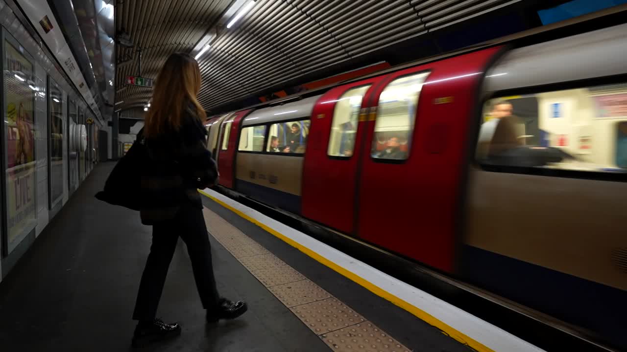 Woman Waiting for Train on London Underground Platform