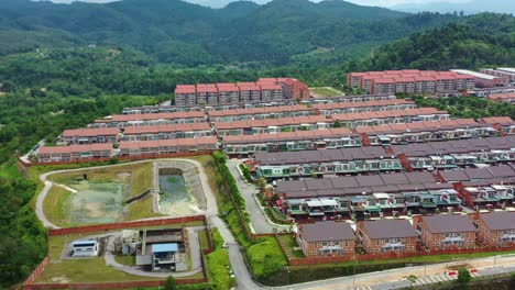 aerial views, drone flyover the goodview heights residential neighborhood featuring rows of double-storey terraced houses constructed by shl consolidated berhad, in kajang, malaysia, southeast asia