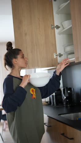 woman cleaning dishes in modern kitchen