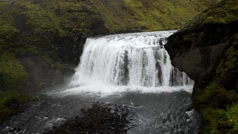 handheld shot of a mighty and powerfull big wide waterfall in iceland