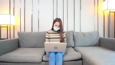 Woman-Working-From-Home-With-Mask-On-During-Pandemic