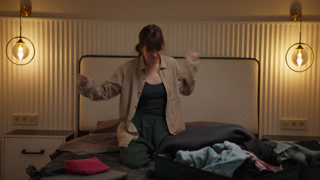 Woman packing suitcase with clothes