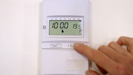 turn-the-heat-down-from-the-thermostat-due-to-high-rise-in-gas-bill-stock-footage