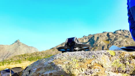 fpv drone dji avata on rock before flying in campagneda pass, valmalenco, italy