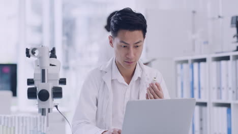 doctor working on a laptop in a medical lab