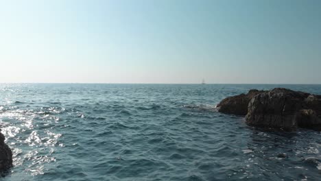 Close-to-water-drone-shot-between-cliffs-and-rocks-near-seashore-4