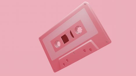 pale pink cassette tape isolated on a pink background.