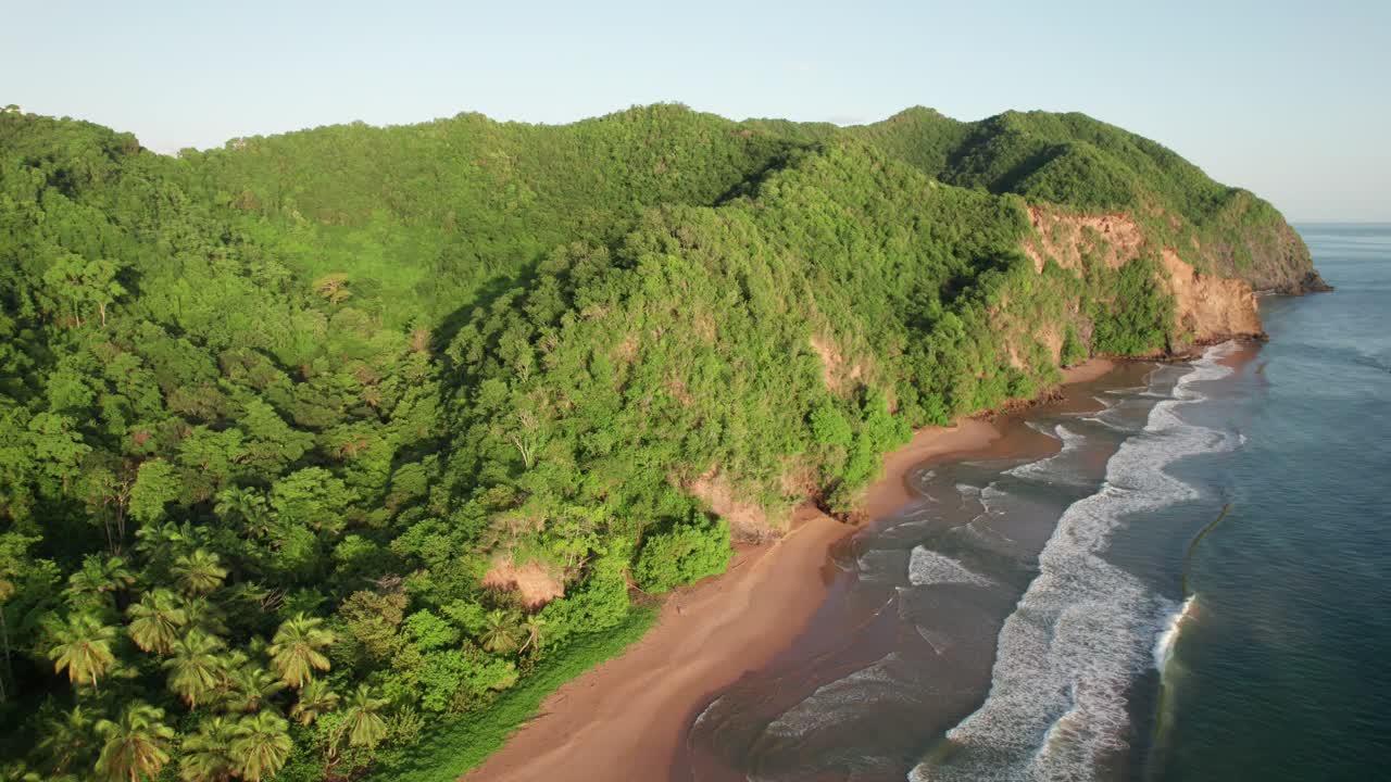 Aerial view of Puy Puy beach and lush mountains at the shoreline