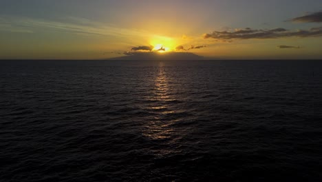 drone captures the ocean during sunset, with golden light reflecting on the waves and a calm, serene mood. a stunning view of nature’s beauty at the end of the day