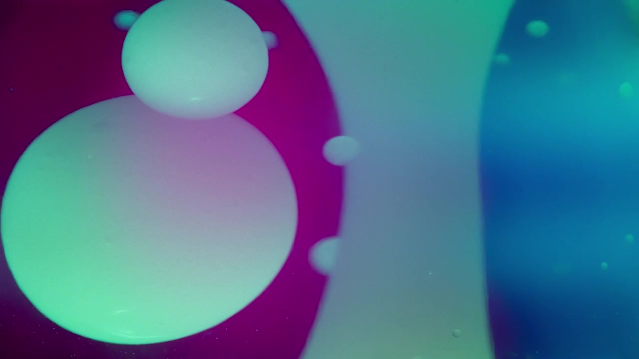 Lava bubbles flowing in liquid against colorful background