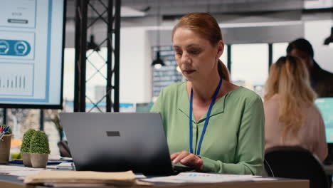 vertical video general director alone at her desk crafts a detailed business strategy