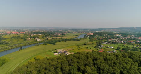 aerial view of landscape and small city agains mountains 1