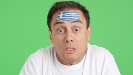 man with greek national flag upset with a referee