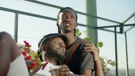 afro-american gay lying on his lover and kissing his