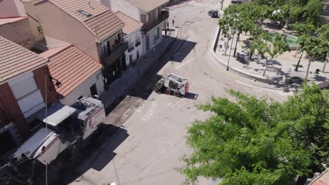 aerial: roadwork in navas del rey, spain - fixining old pavement road