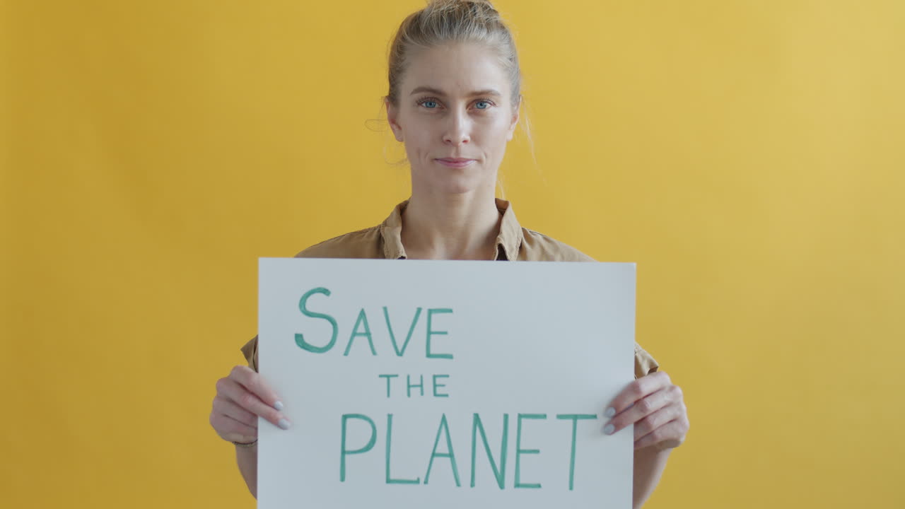 Woman Holding a Sign Saying 'Save The Planet'