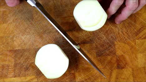 cutting onion in half with a knife