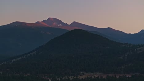 aerial view of mountains at twilight, with warm light illuminating the peaks and valleys