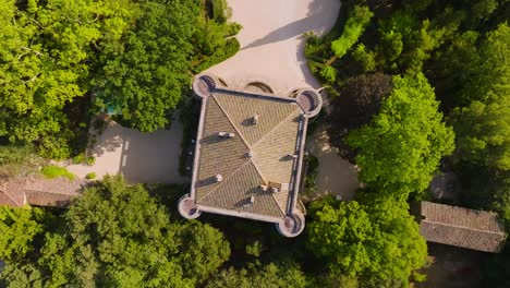 Top-down-rising-shot-of-the-Chateau-de-Castille-surrounded-by-vineyards-in-Uzes
