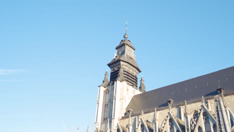 old medieval roman catholic church of our blessed lady of sablon in brussels, belgium with sunlight shining on it on warm sunny day