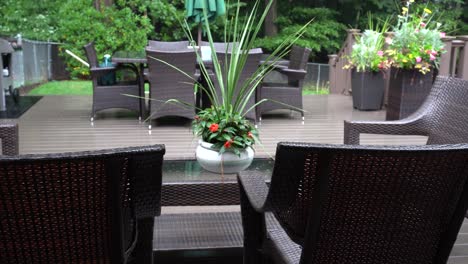 Rain-lightly-pattering-on-a-suburban-deck-during-a-summer-storm