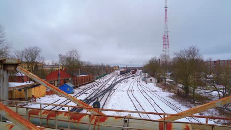 eastern european industrial city establishing shot with railway tracks in snow