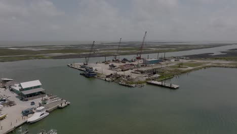 Aerial-view-of-Cove-harbor-marina-and-shipyard-in-Rockport,-texas-in-4K