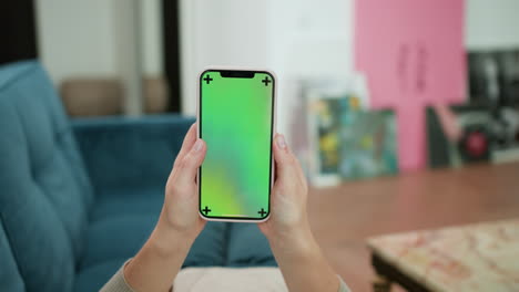 woman scrolling on smartphone at home