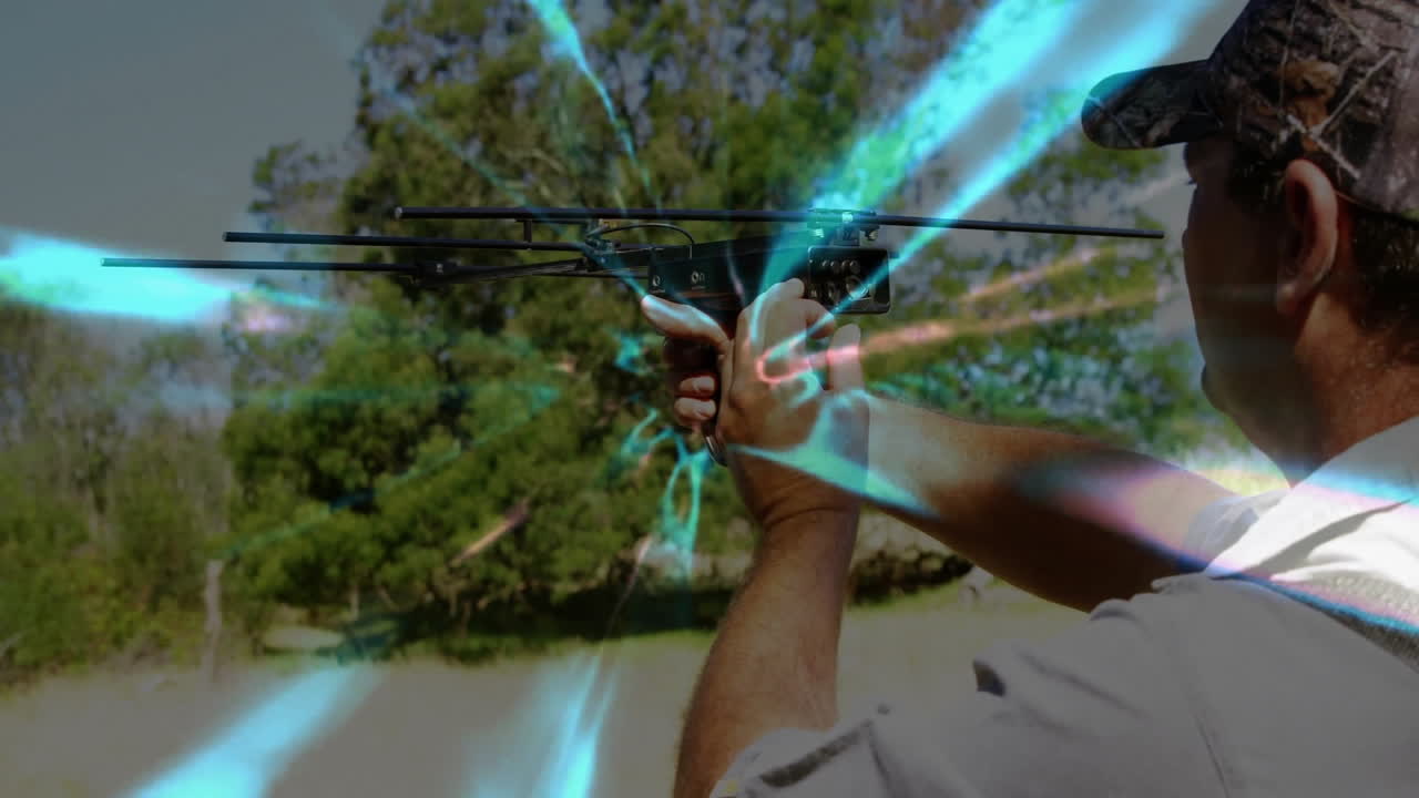 man holding and aiming multi-rod antenna device in rural field, showing wireless technology signals