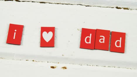 text i love dad arranged on blocks arranged on wooden plank