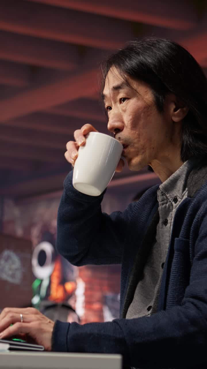 Vertical video CTO manager in AI startup drinking coffee while coding