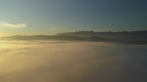 Vivid-Clouds-Over-Forested-Mountains-During-Foggy-Day