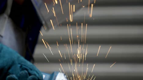 Female-welder-using-grinder-in-workshop-4k