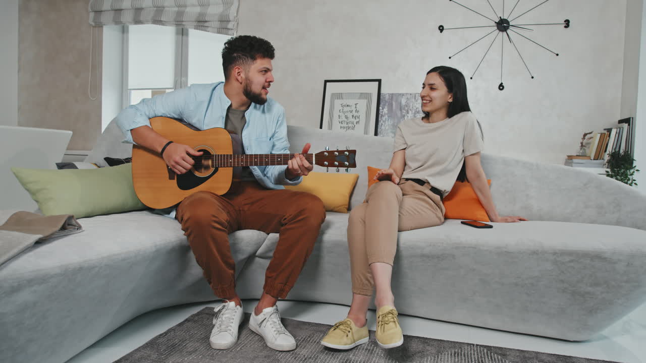 Latin Man Playing Guitar And Singing To His Love