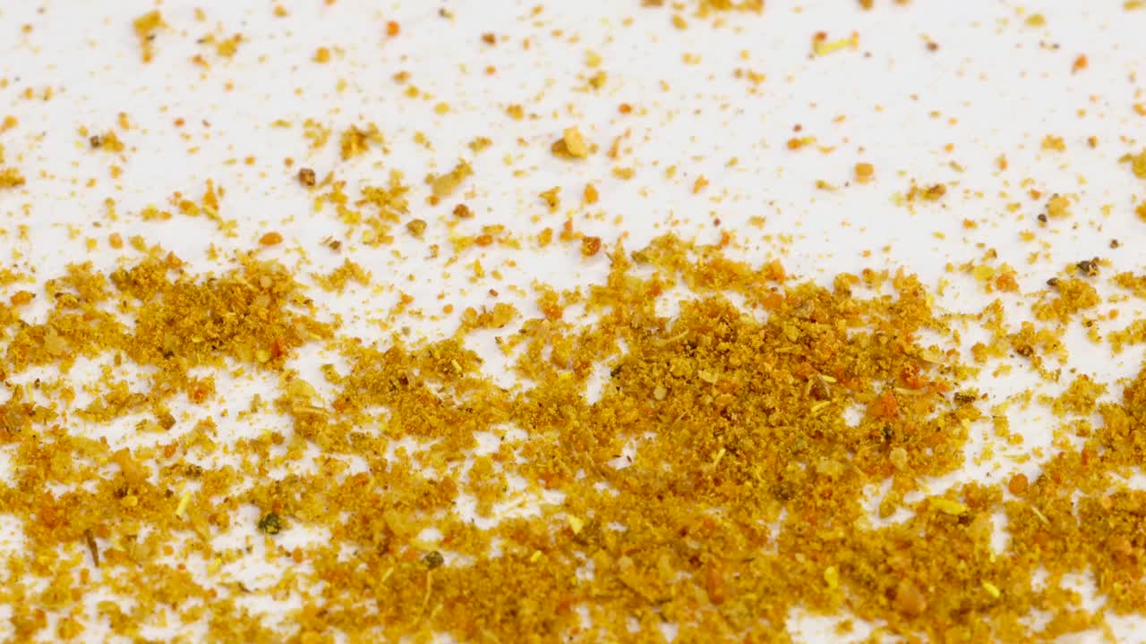 흰색 표면에 떨어지는 카레 가루