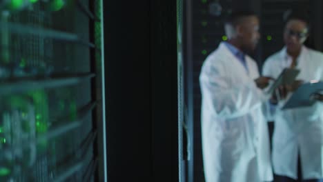 african american male computer technicians using tablet working in business server room