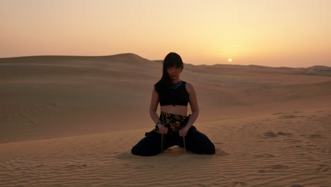 Woman-Performing-Dance-in-the-Desert-at-Sunset