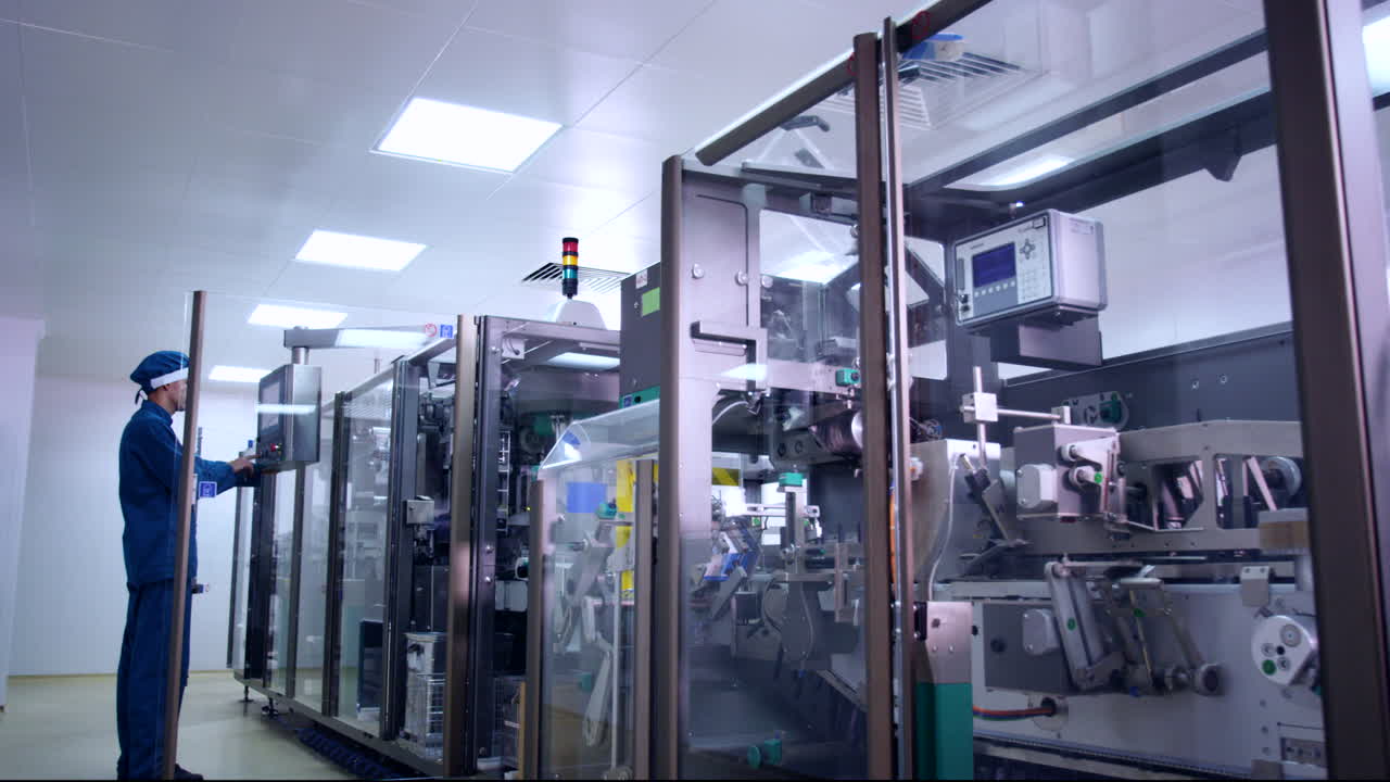 Pharmaceutical industry. Pharmaceutical worker operating pharmacy equipment