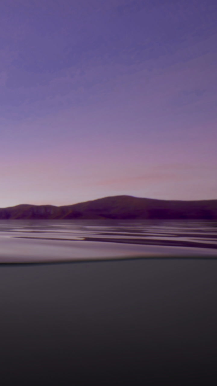 Reflection on water at sunset near hills with a colorful sky