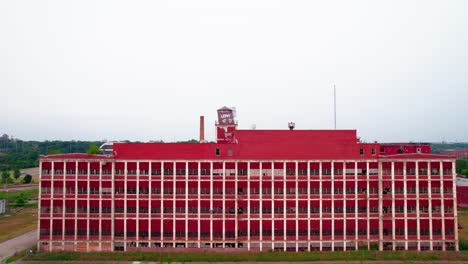 slow-rising-complex-aerial-Dramatic-Red-abandoned-building-with-a-strong-symmetry-and-pattern