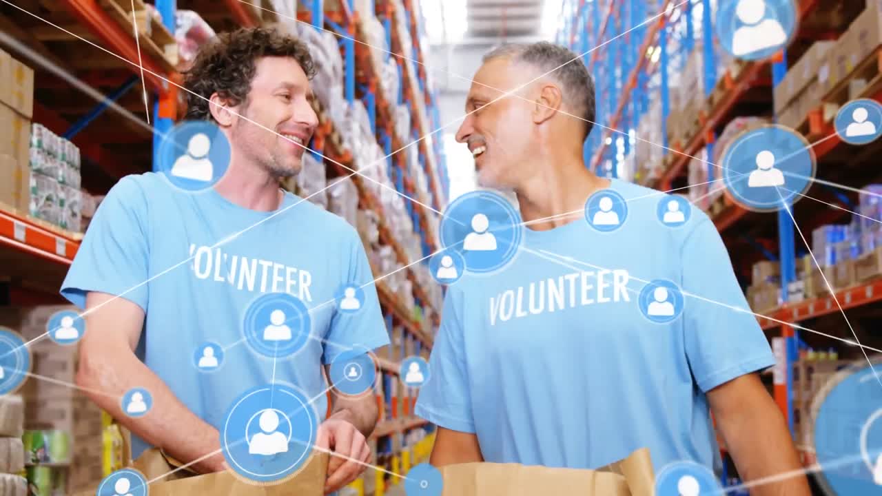 Animation of network of profile over two diverse male volunteers high fiving each other at warehouse