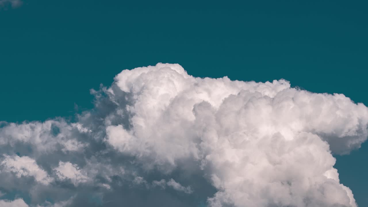 White Cumulus Cloud in Teal Sky