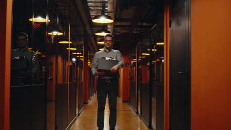 fired man saying goodbye to colleagues fired upset man in suit walking down in office hallway holding box with books and personal stuff saying goodbye to colleagues looking at camera male employee leaving marketing company