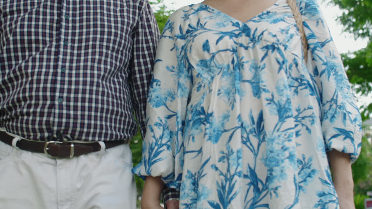 Elderly Asian Spouses Spending Time Together in Park