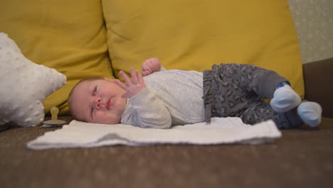 baby yawning expression while sleeping lied down on a blanket bed, side shot, close-up, isolated