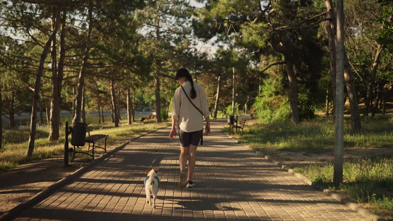 mujer paseando a su perro en un parque